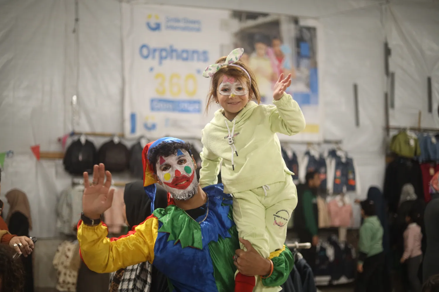 Orphan children enjoying entertainment and face painting at SGI event